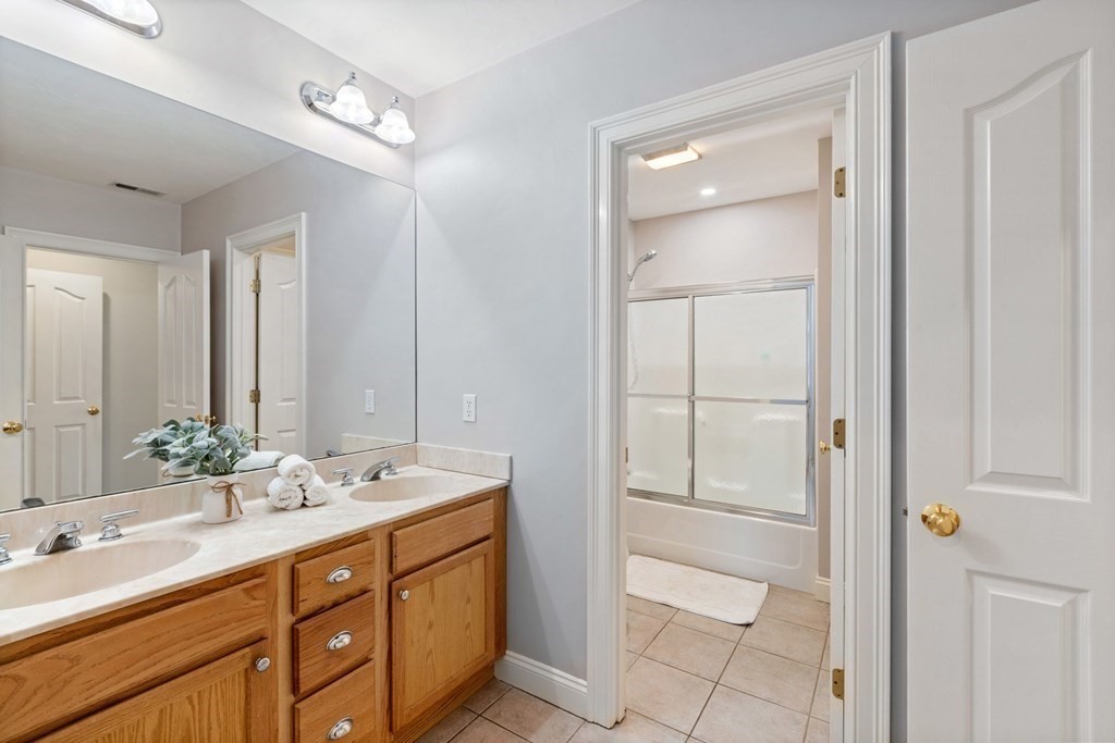 5 Rolling Meadow Drive Millis, MA 02054 - Photo 33 of 42 a bathroom with a double vanity sink and a mirror