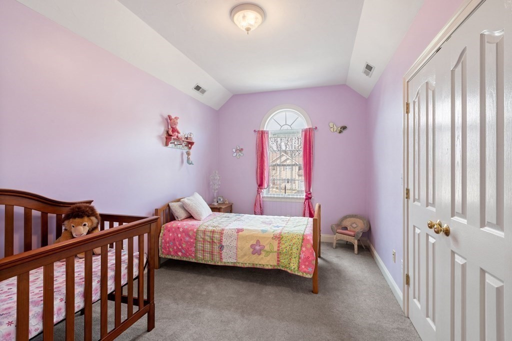 5 Rolling Meadow Drive Millis, MA 02054 - Photo 34 of 42 a bedroom with a bed and a chandelier