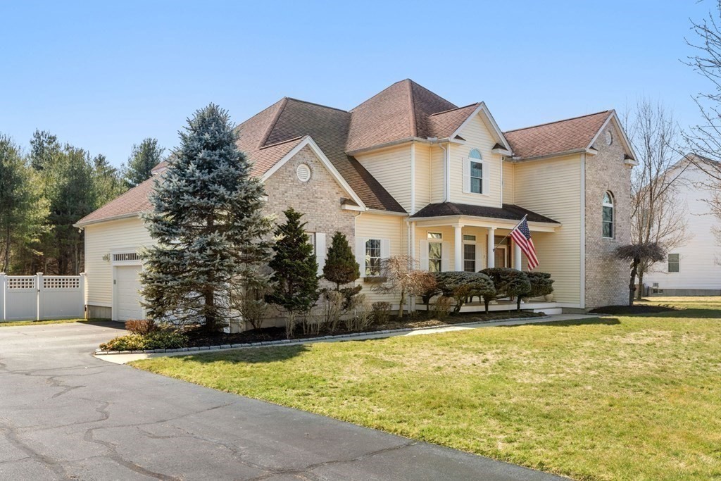 5 Rolling Meadow Drive Millis, MA 02054 - Photo 4 of 42 a front view of house with yard and trees in the background