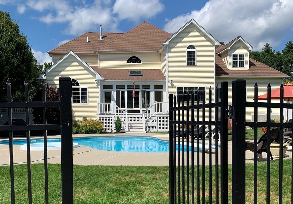 5 Rolling Meadow Drive Millis, MA 02054 - Photo 42 of 42 a view of a white house in front of a yard and deck