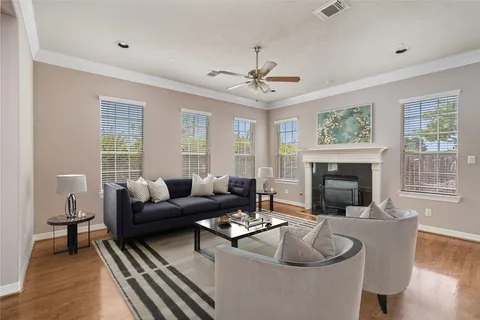 a living room with furniture a fireplace and a large window