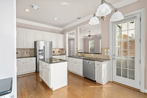 a kitchen with stainless steel appliances a stove refrigerator sink and cabinets