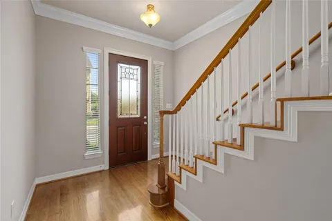 a view of entryway and hall with wooden floor