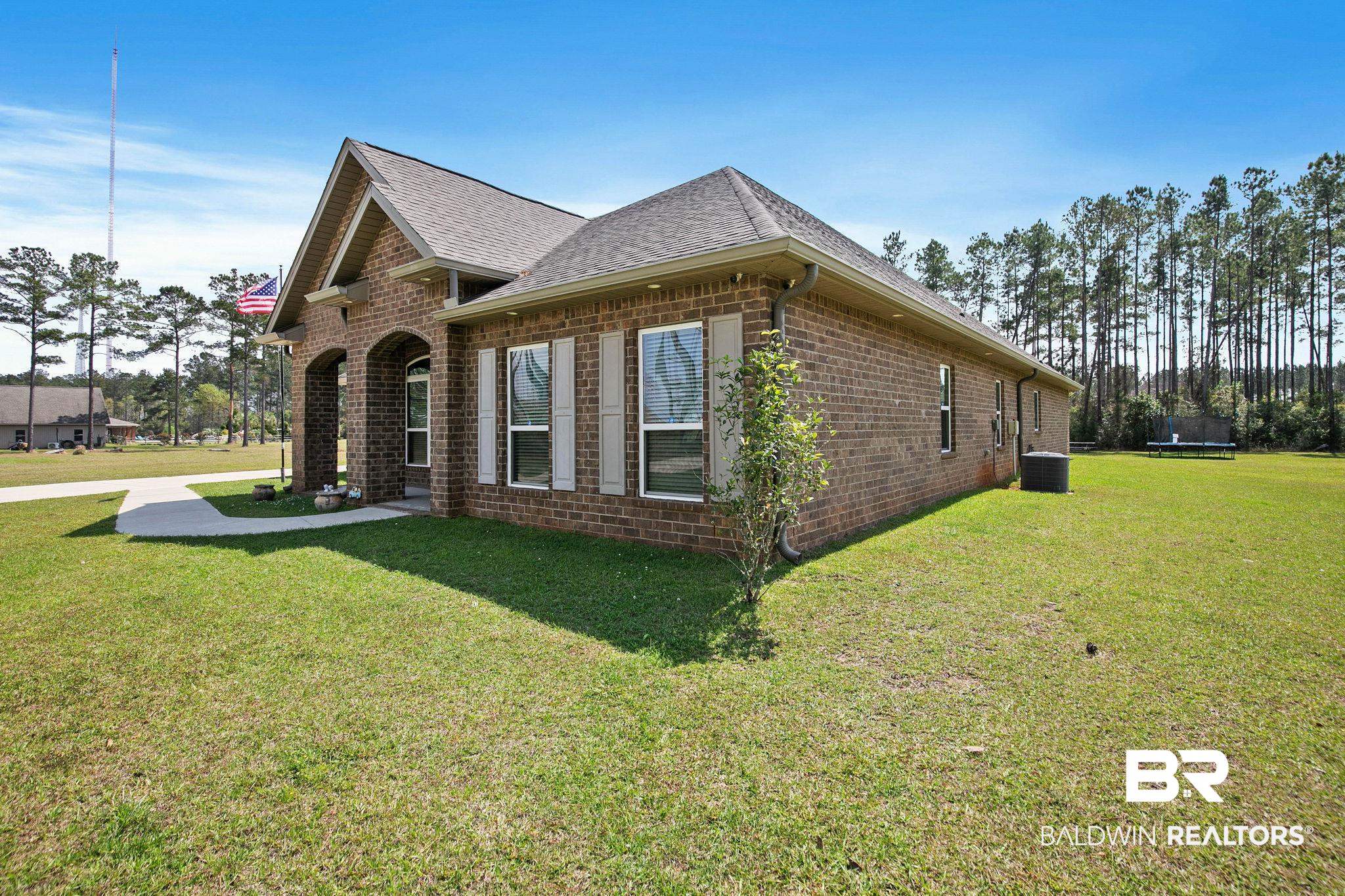 12750 B Jenkins Pit Road Daphne, AL 36527 - Photo 79 of 89 View of home's exterior with brick siding, a yard, and a shingled roof