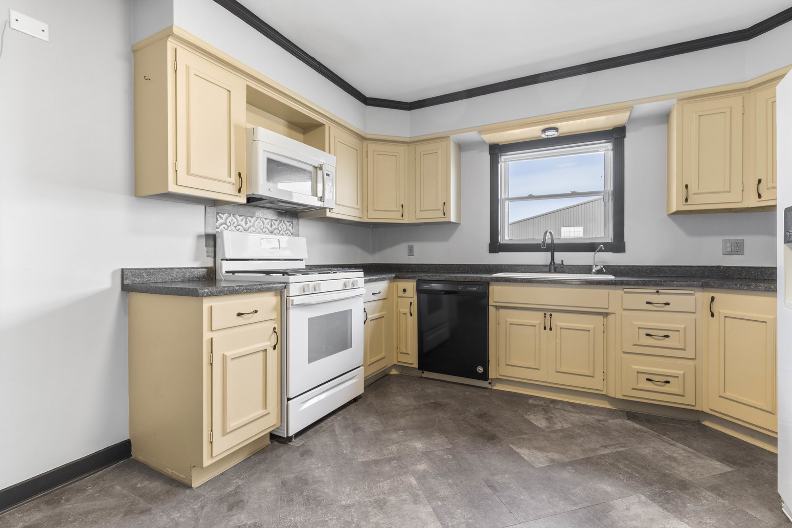 1082 North 8th Street Rochelle, IL 61068 - Photo 6 of 22 a kitchen with white cabinets and white appliances