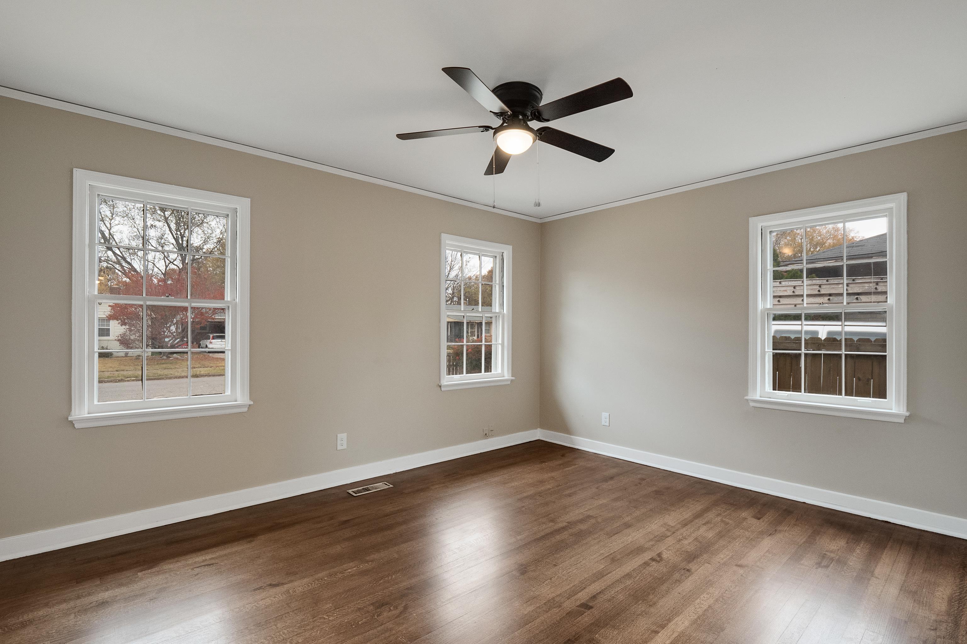 4329 Jamerson Road Memphis, TN 38122 - Photo 19 of 33 a view of an empty room with wooden floor and a window