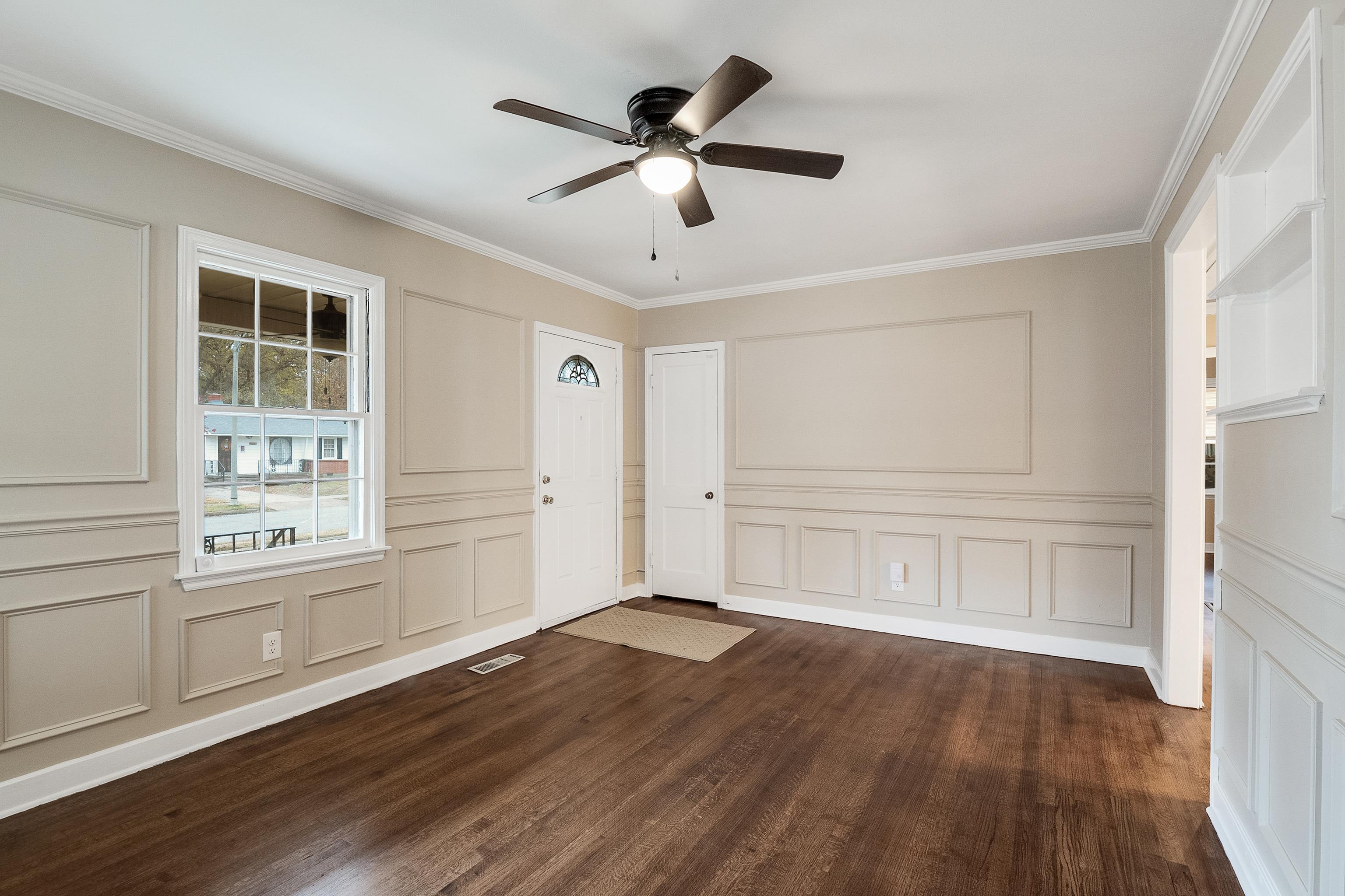 4329 Jamerson Road Memphis, TN 38122 - Photo 4 of 33 an empty room with wooden floor cabinet and windows