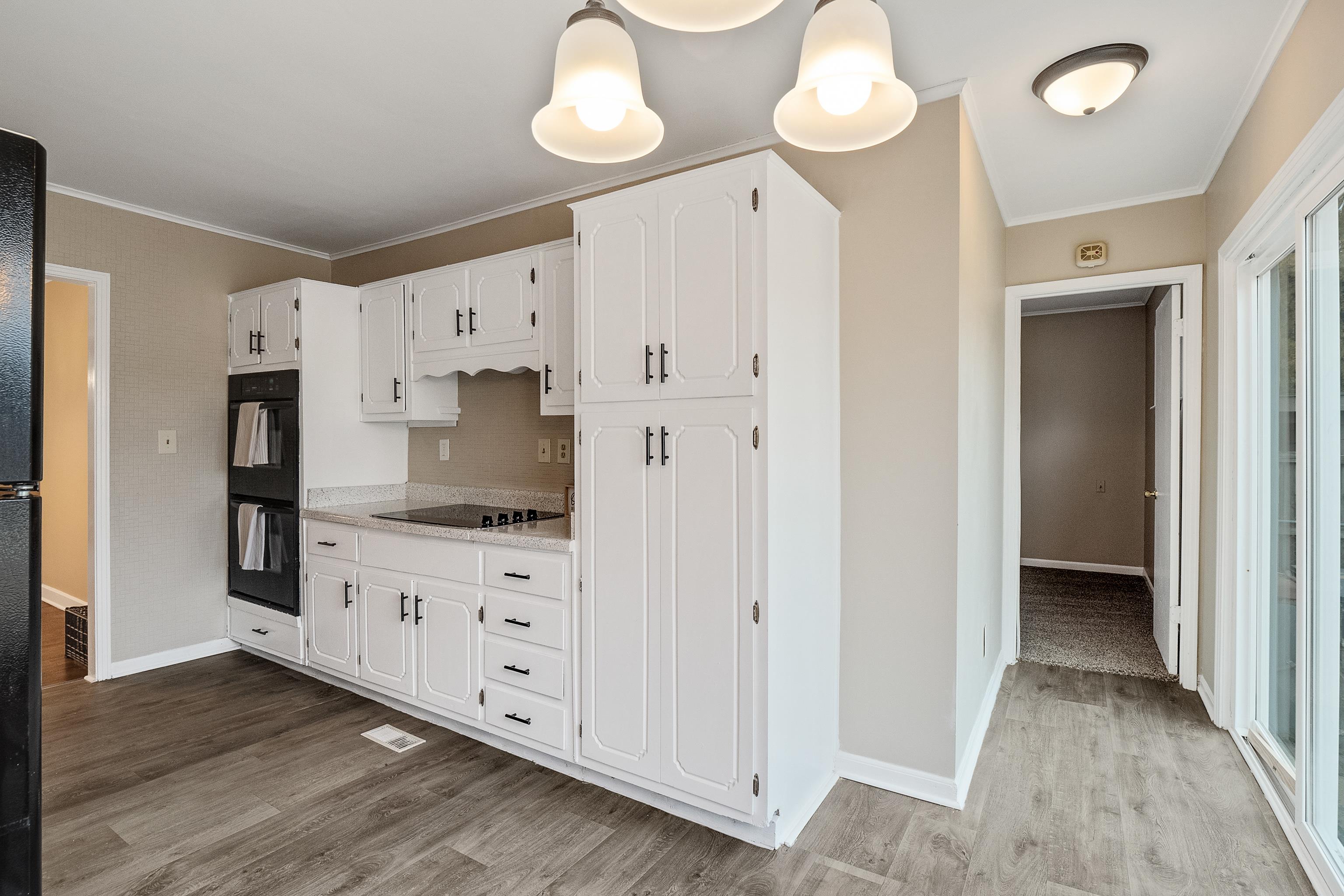 4329 Jamerson Road Memphis, TN 38122 - Photo 8 of 33 a large kitchen with cabinets and wooden floor