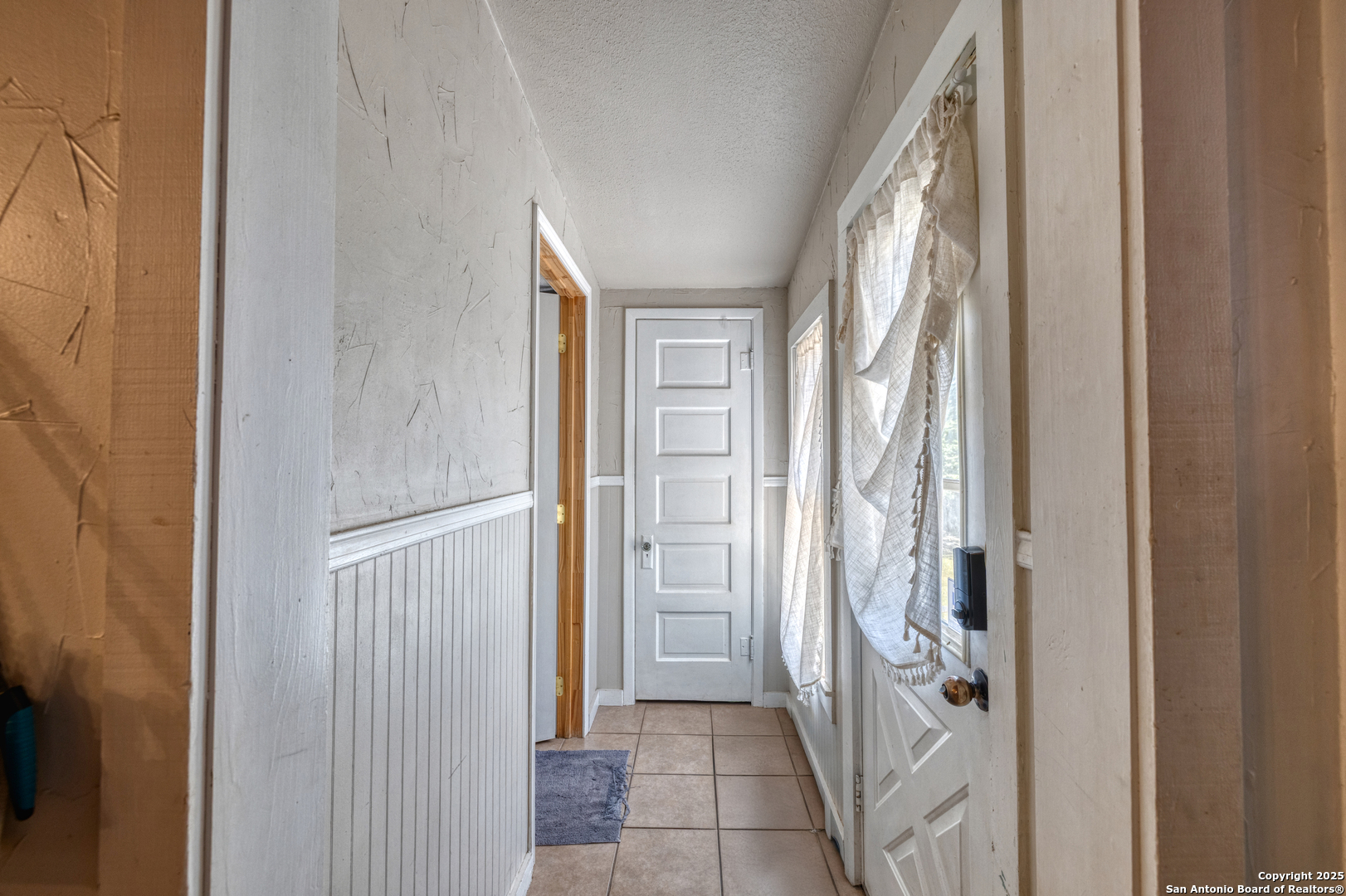 518 North Getty Street Uvalde, TX 78801 - Photo 14 of 31 a view of a hallway with wooden shelves