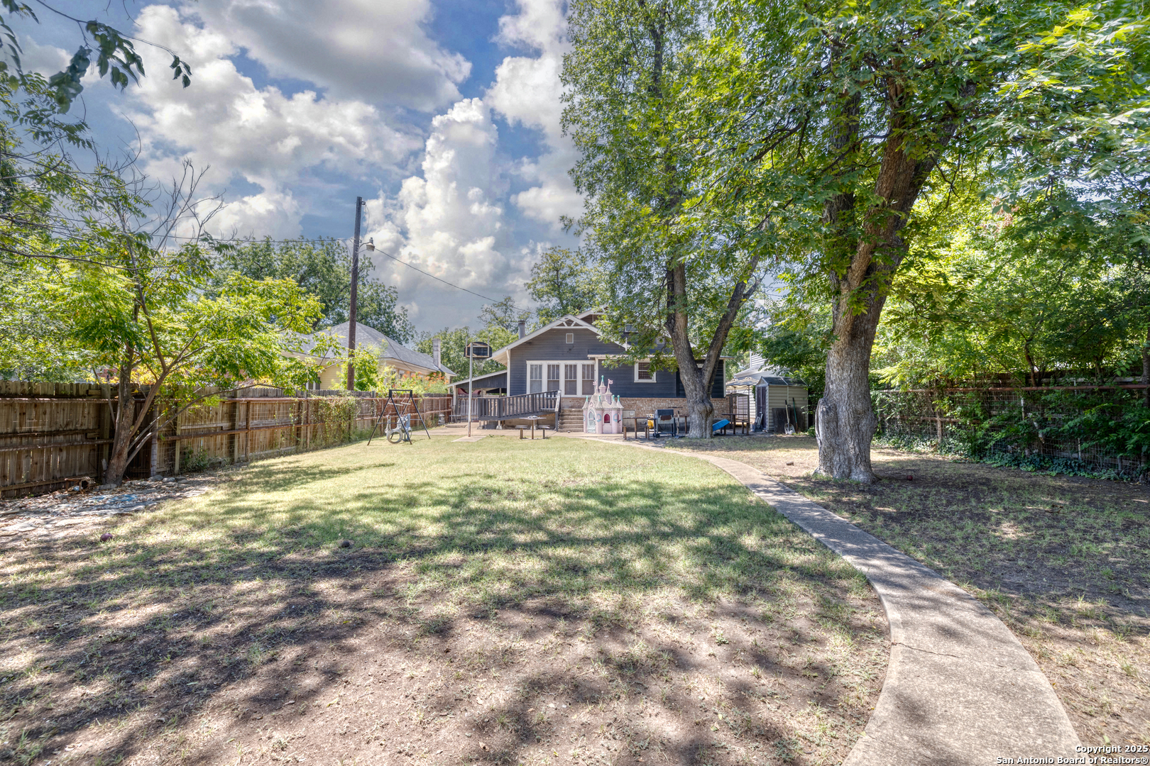 518 North Getty Street Uvalde, TX 78801 - Photo 25 of 31 a house with trees in front of it