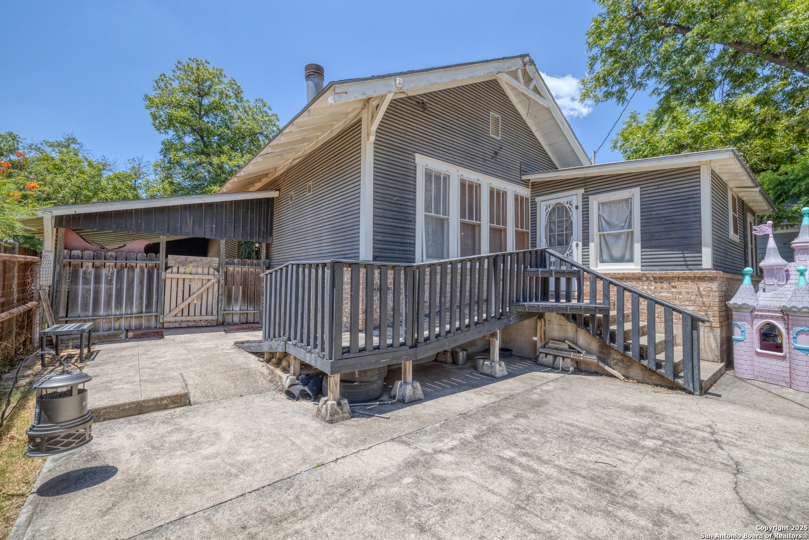 518 North Getty Street Uvalde, TX 78801 - Photo 28 of 31 a view of a house with wooden deck and furniture