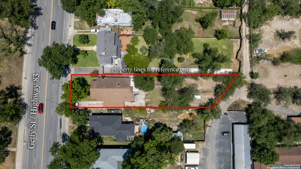 an aerial view of a house with yard and outdoor seating