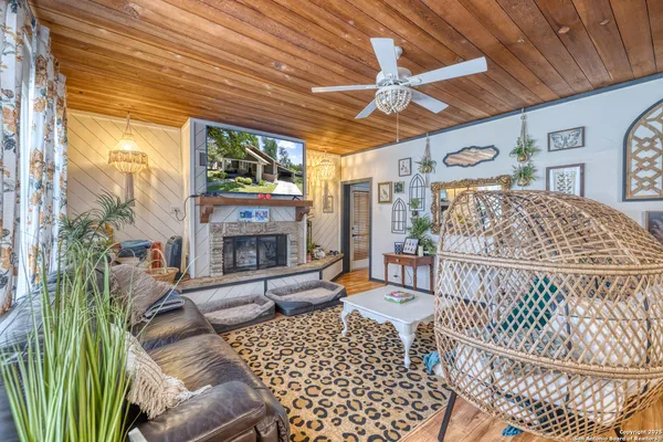 a living room with furniture a fireplace and a table