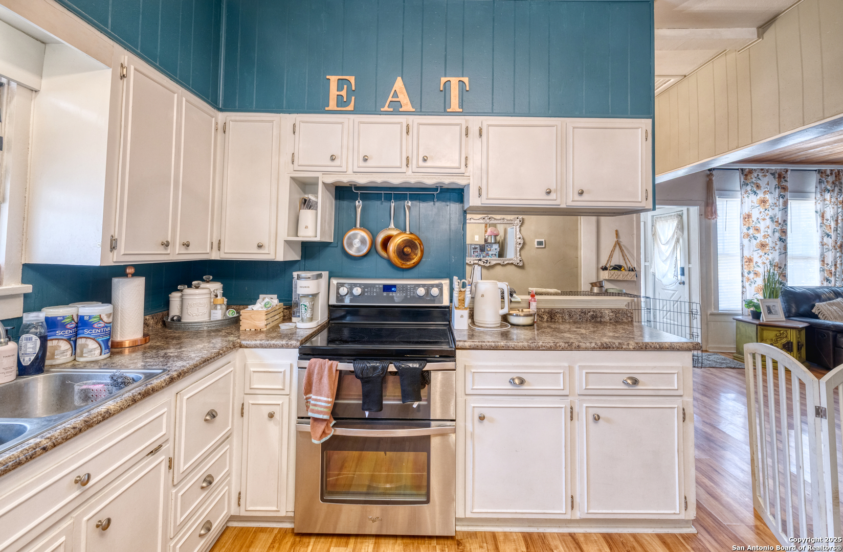 518 North Getty Street Uvalde, TX 78801 - Photo 5 of 31 a kitchen with stainless steel appliances granite countertop a stove a sink and a white cabinets