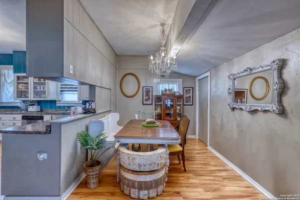 a dining room with granite countertop furniture a rug and stainless steel appliances
