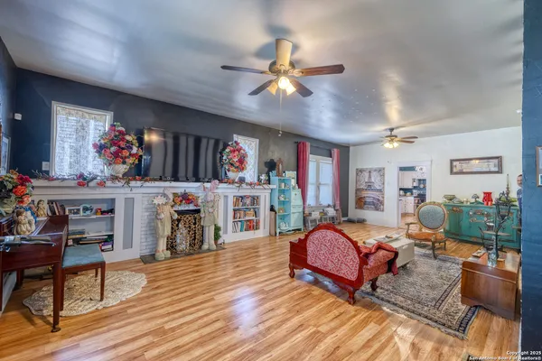 a living room with furniture a flat screen tv and a rug