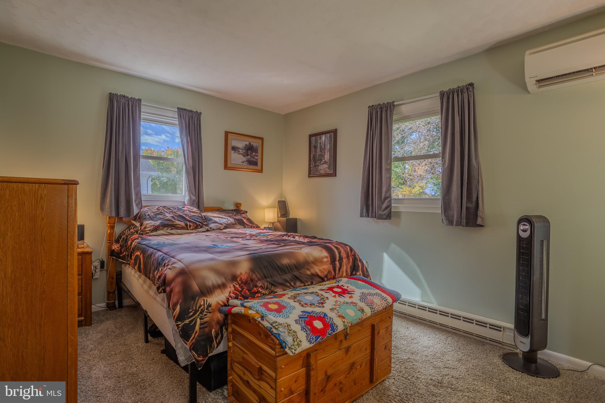 106 McDonald Street Ranson, WV 25438 - Photo 12 of 27 a bedroom with a bed and a dresser next to a window