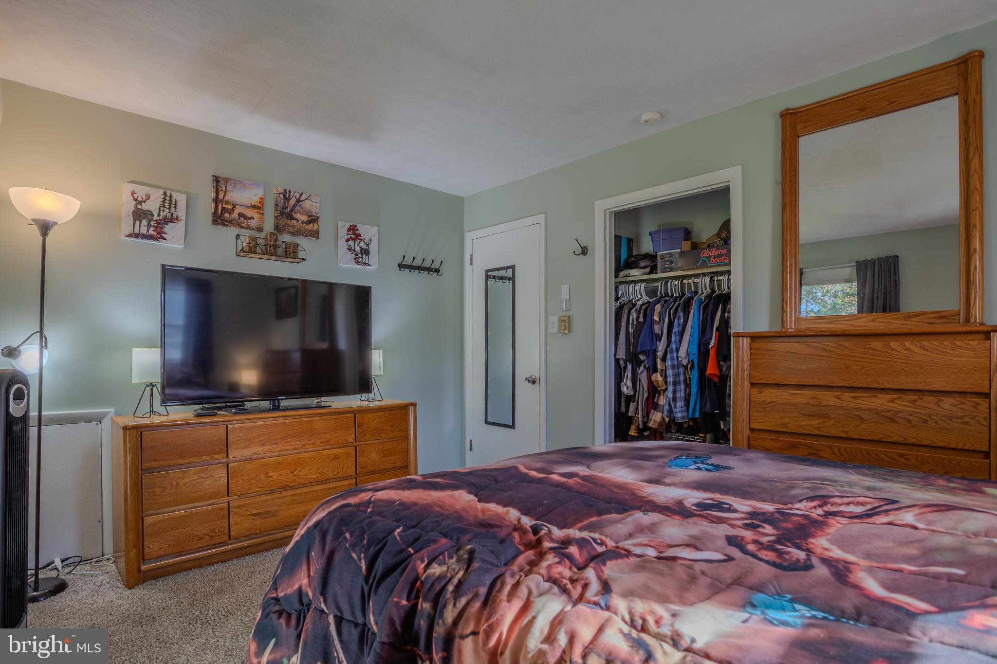 106 McDonald Street Ranson, WV 25438 - Photo 13 of 27 a bedroom with a bed and a flat screen tv