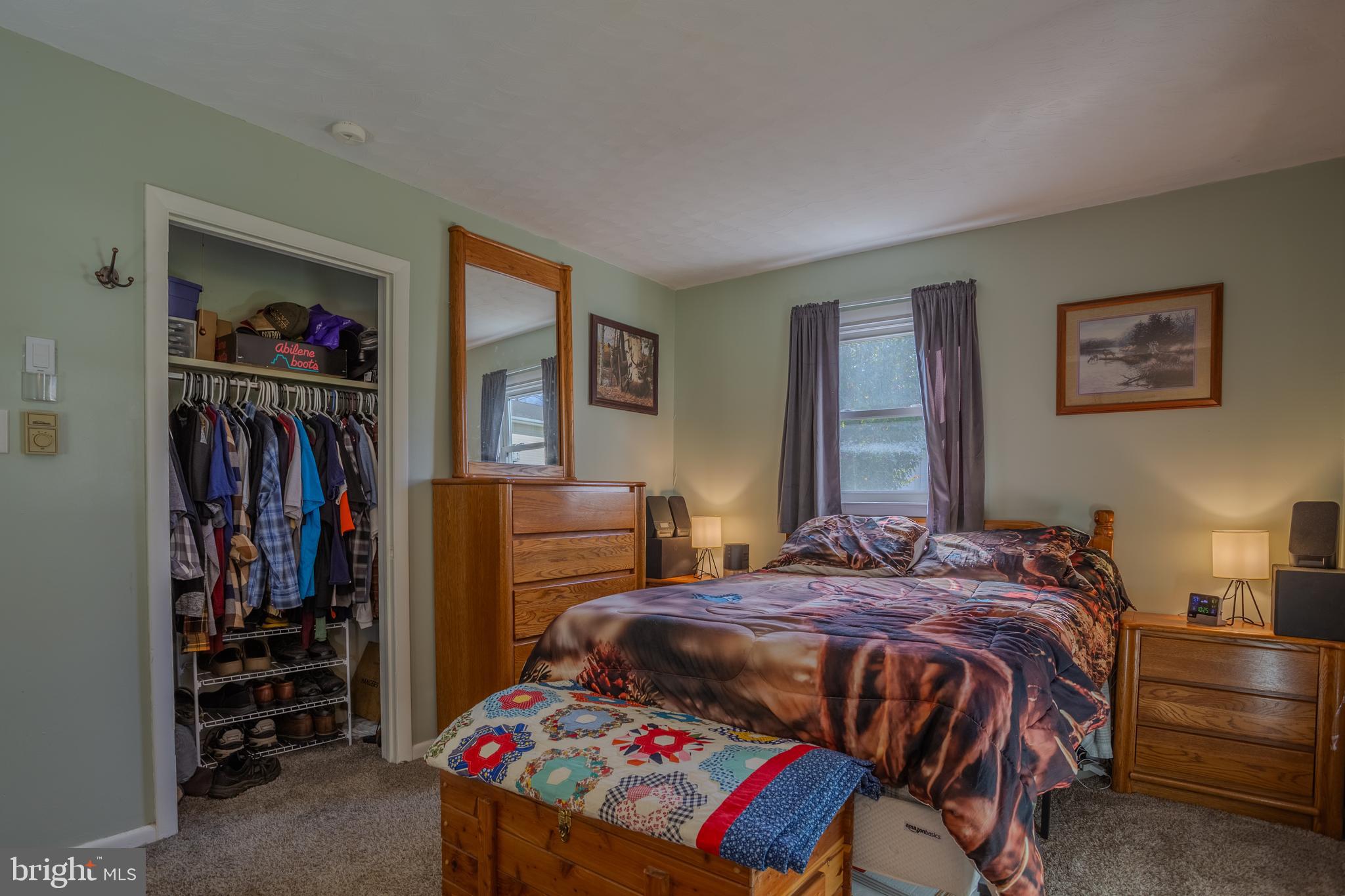 106 McDonald Street Ranson, WV 25438 - Photo 14 of 27 a bedroom with a bed a dresser and book shelf