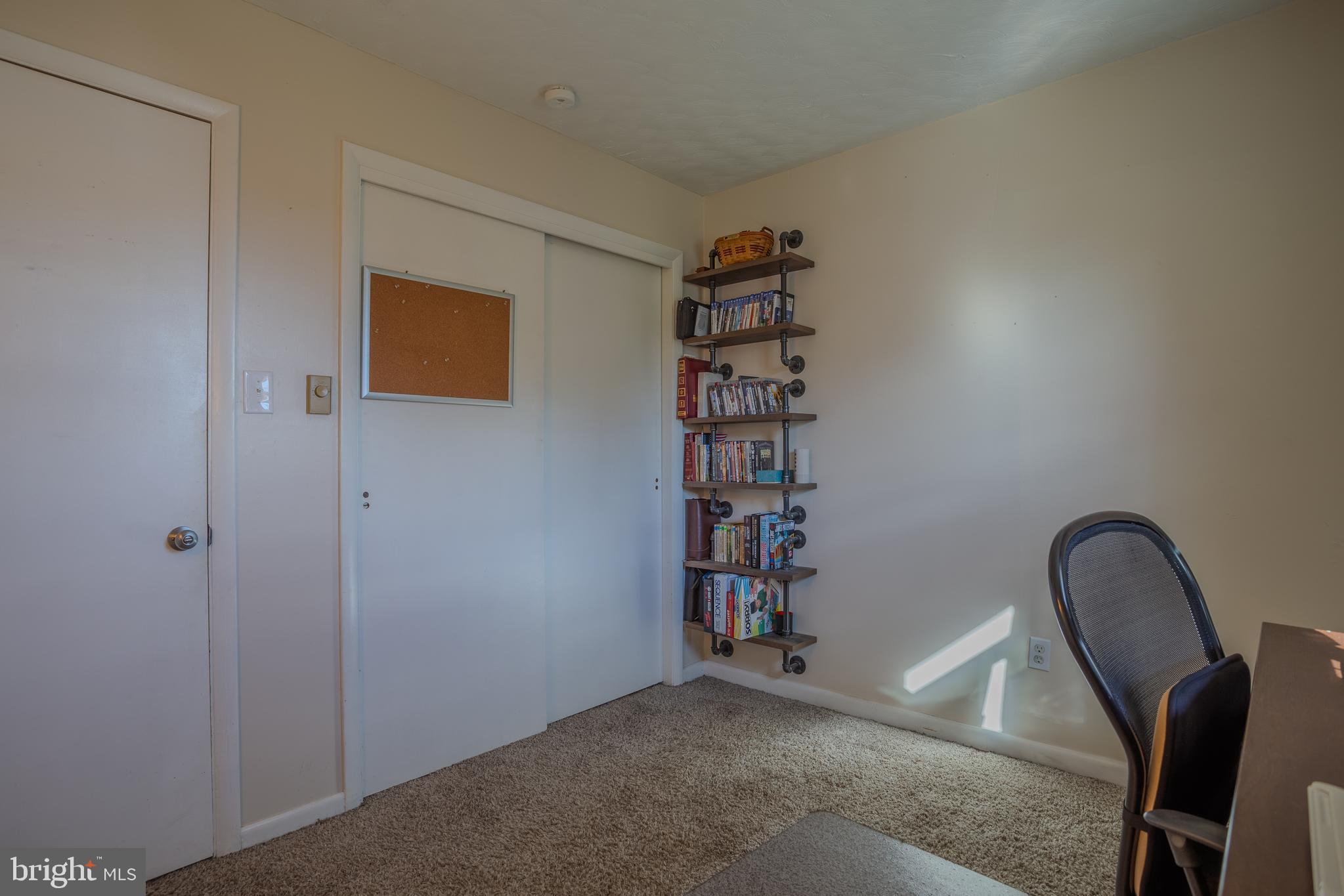 106 McDonald Street Ranson, WV 25438 - Photo 20 of 27 a view of a livingroom with a bookshelf and a piano in it