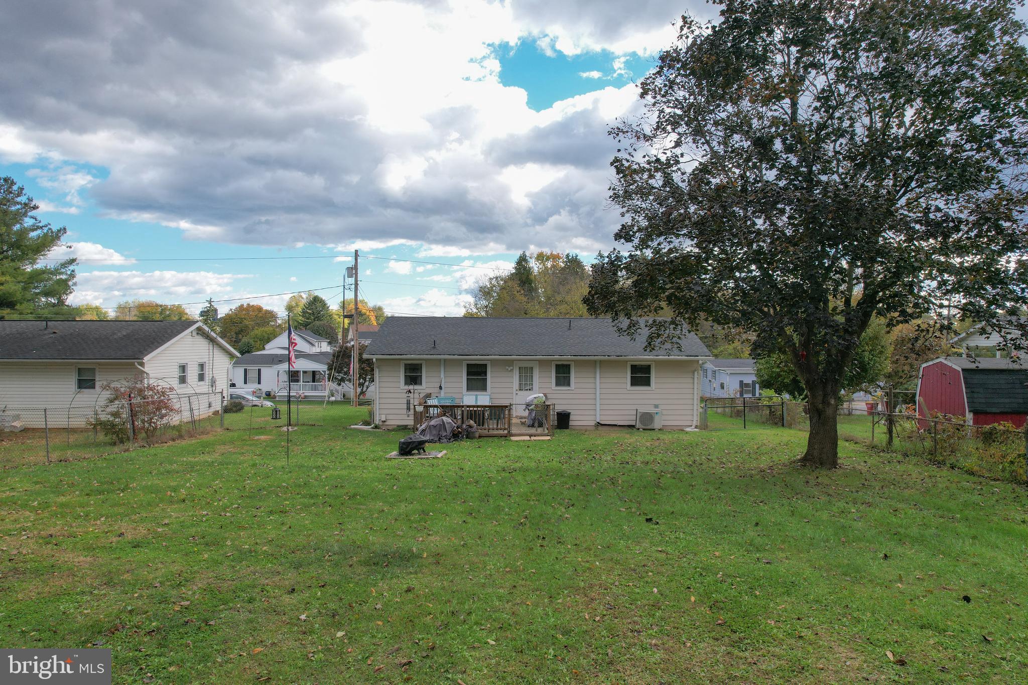 106 McDonald Street Ranson, WV 25438 - Photo 24 of 27 a view of a house with a big yard and large trees