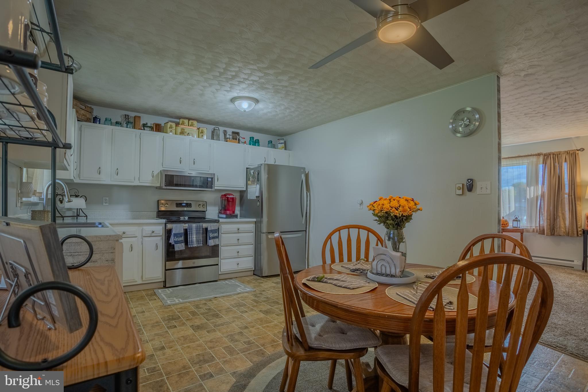106 McDonald Street Ranson, WV 25438 - Photo 8 of 27 a kitchen with stainless steel appliances a table and chairs