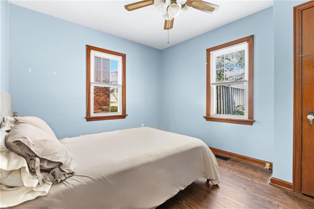 118 Oak Spring Road Canonsburg, PA 15317 - Photo 15 of 32 Cozy bedroom with hardwood floors and a neutral palette, offering flexibility for a guest room or home office. Ceiling fan and ample windows enhance comfort and brightness.
