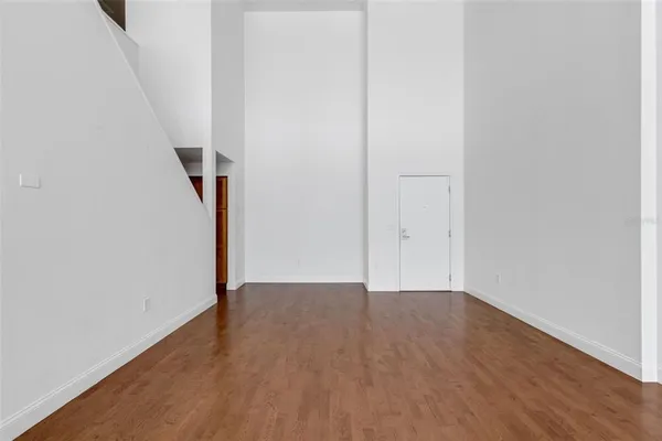 an empty room with wooden floor