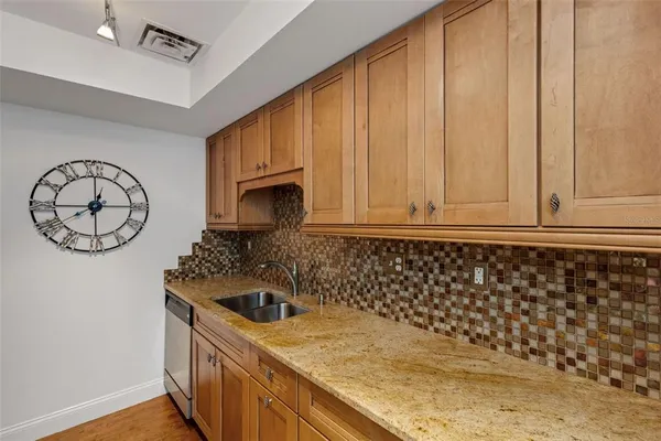 a view of empty room with wooden floor and fireplace
