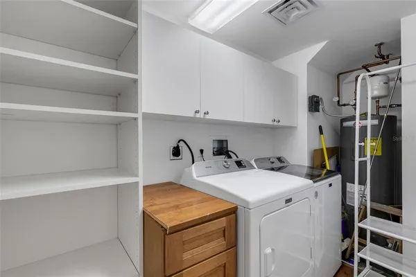 a view of staircase with railing and white walls