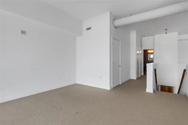 a large white kitchen with a large window