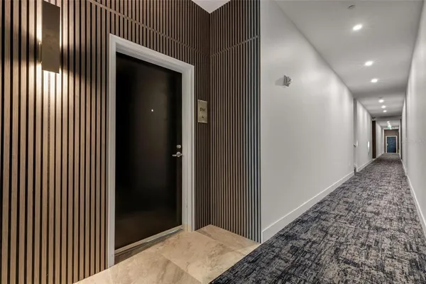 a living room with furniture a flat screen tv and a large window