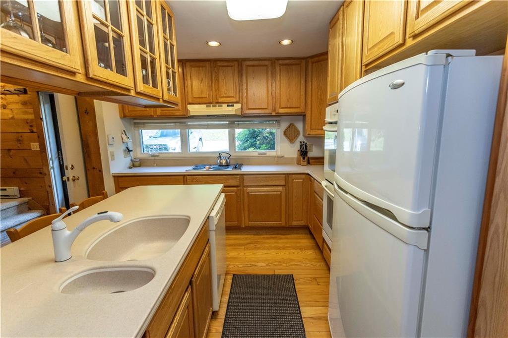 13 Lakeview Road Hidden Valley, PA 15502 - Photo 11 of 33 a kitchen with granite countertop a sink and a refrigerator