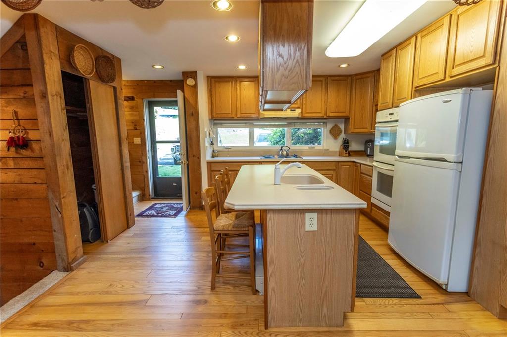 13 Lakeview Road Hidden Valley, PA 15502 - Photo 9 of 33 a kitchen with a sink a refrigerator and wooden floor