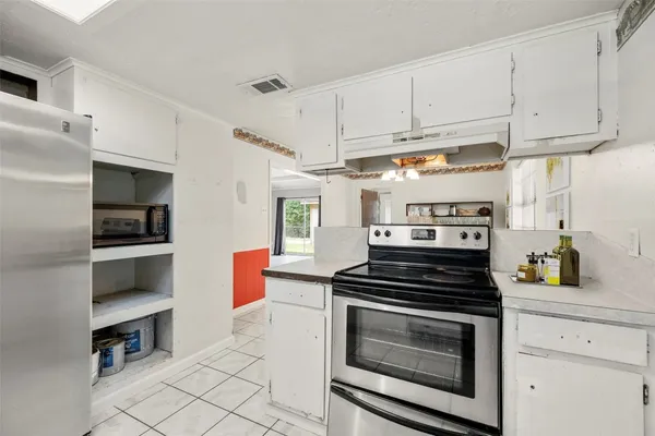 a kitchen with cabinets and appliances