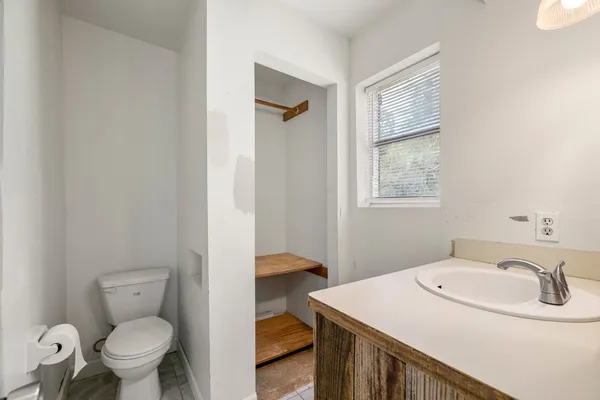 a bathroom with a sink toilet and vanity