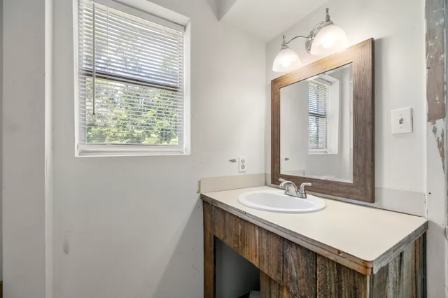 a bathroom with a sink vanity and a mirror