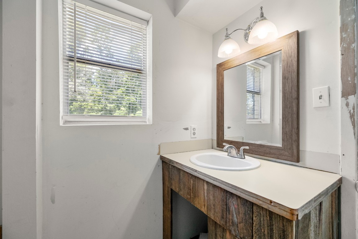 140 Friar Tuck Road Shepherd, TX 77371 - Photo 16 of 36 a bathroom with a sink vanity and a mirror