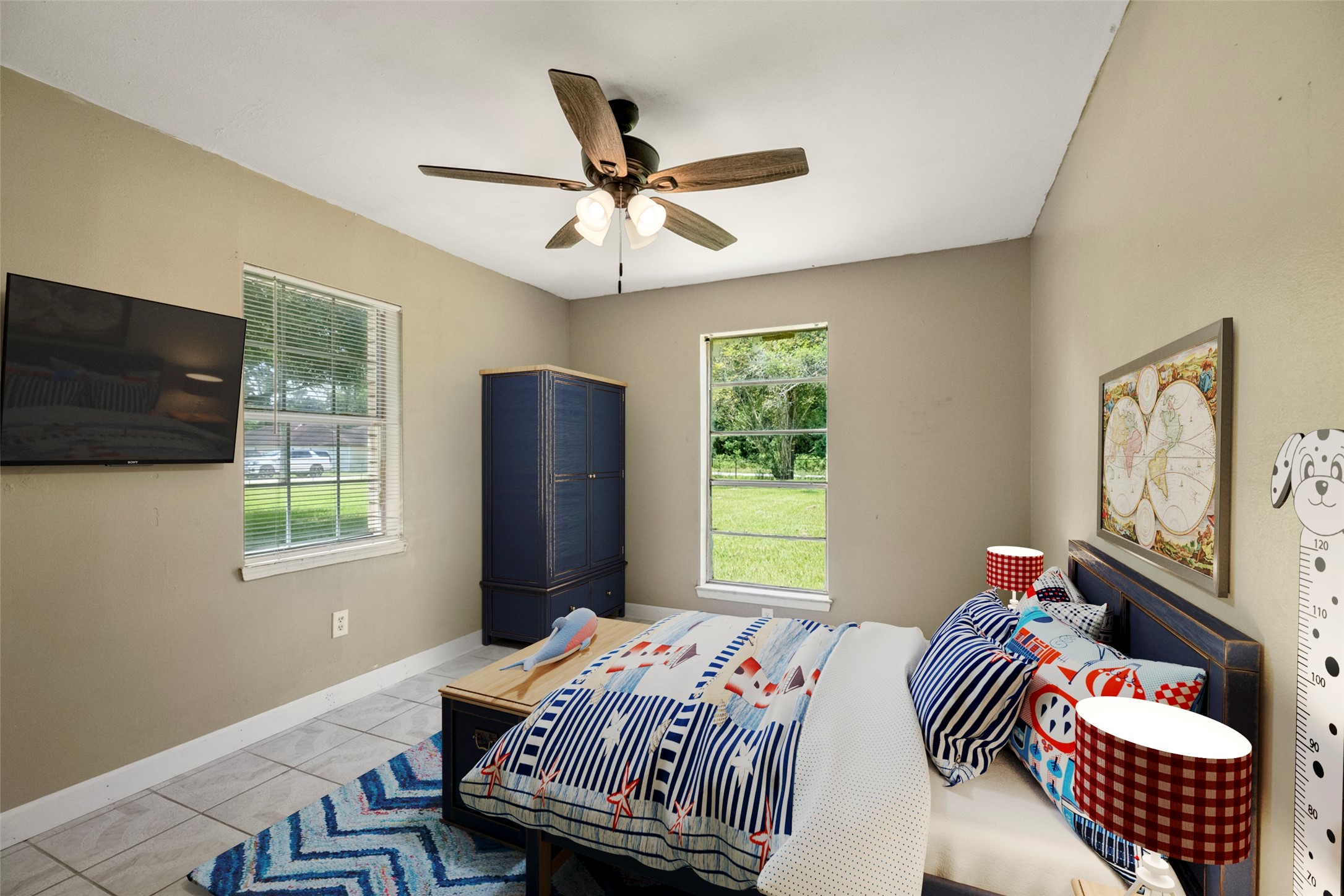 140 Friar Tuck Road Shepherd, TX 77371 - Photo 17 of 36 a bedroom with a bed and a chandelier