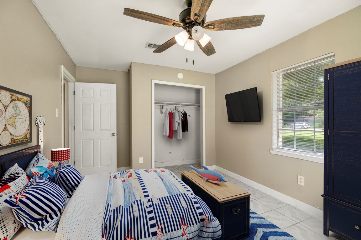 140 Friar Tuck Road Shepherd, TX 77371 - Photo 18 of 36 a bedroom with a bed and a flat screen tv
