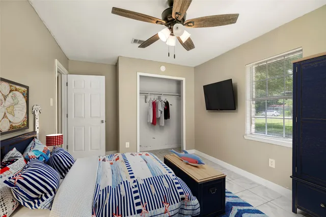 a bedroom with bed and a flat screen tv