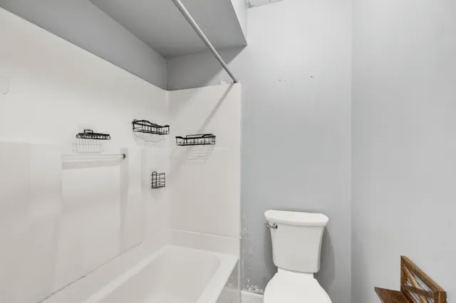 a bathroom with a toilet and shower