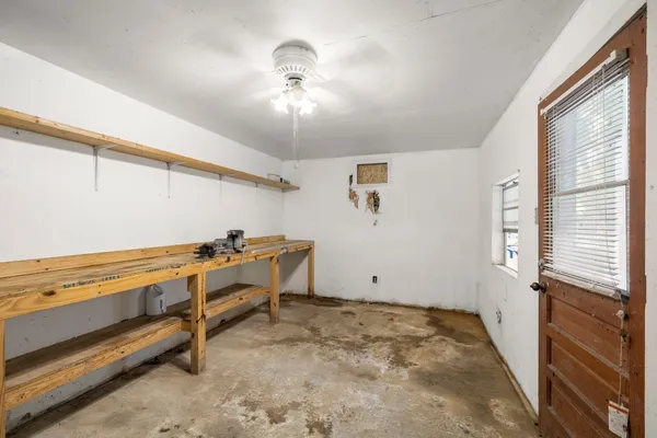 a room with table chairs and window