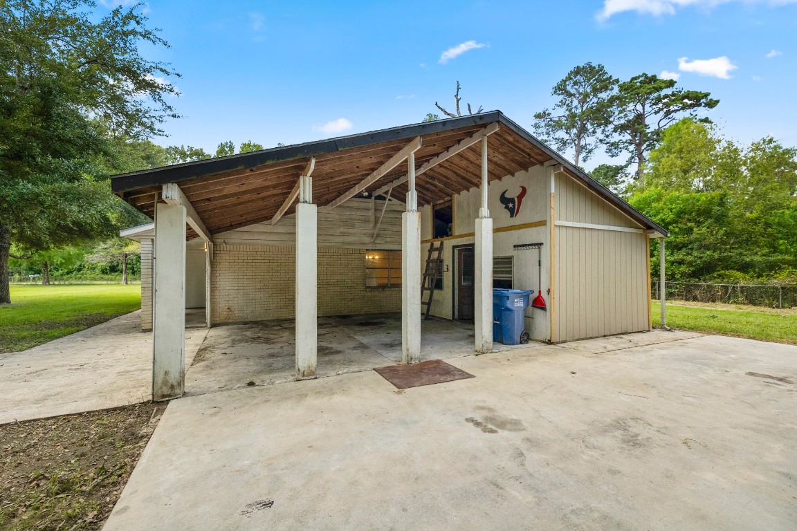 140 Friar Tuck Road Shepherd, TX 77371 - Photo 30 of 36 a view of a house with a yard and garage