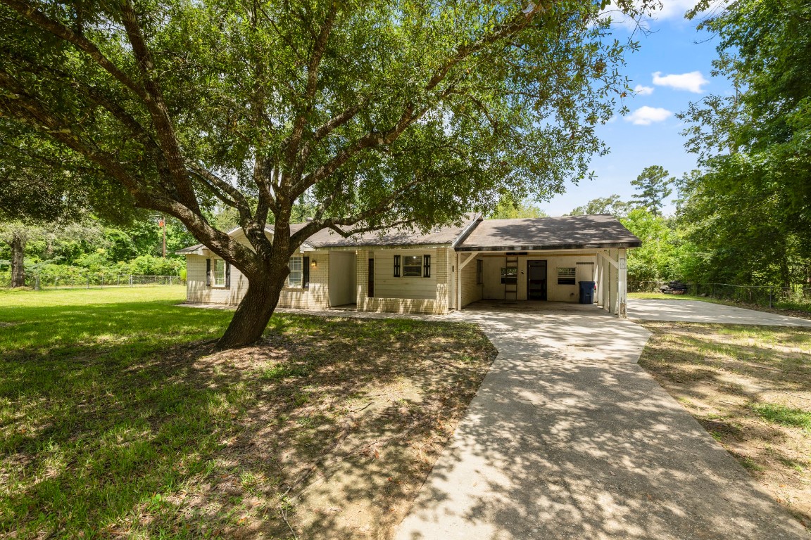 140 Friar Tuck Road Shepherd, TX 77371 - Photo 3 of 36 a front view of a house with garden