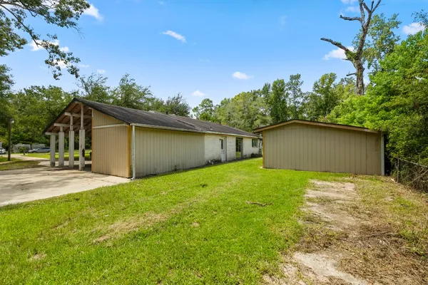a view of backyard of house and garage