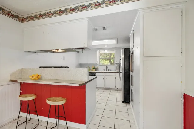 a kitchen with a refrigerator and countertop