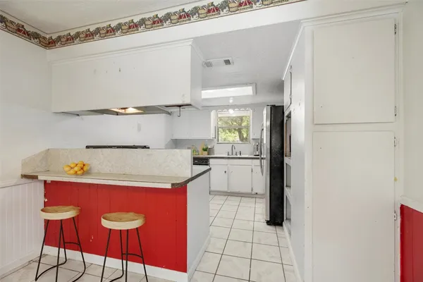 a kitchen with a refrigerator and countertop