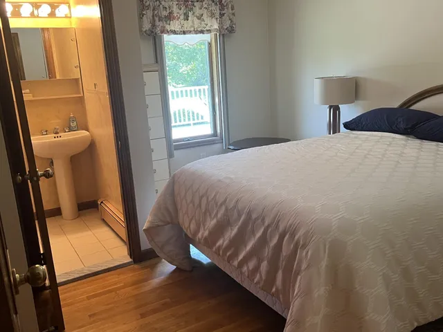 a bedroom with a bed and a mirror