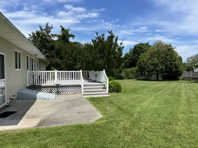 a view of a house with backyard and a garden
